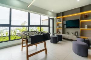 a living room with a ping pong table and chairs at Ejército City Lofts & Apartments by Geko in Lima