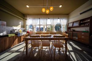 a kitchen with a dining room table and chairs at The Cottage Stay - self check-in in Kuching