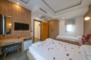 a bedroom with two beds with flower petals on it at Orion hotel in Bodrum City +34 photos