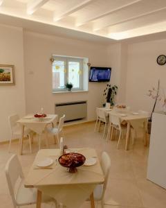a dining room with white tables and white chairs at Tenuta Vigna del Noce in Corato