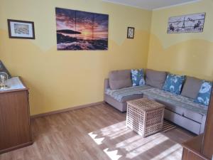 a living room with a couch and a table at Appartamento Cascate delle Marmore in Le Marmore