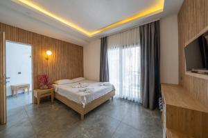 a hotel room with a bed and a television at Orion hotel in Bodrum City