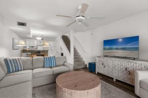 a living room with a couch and a table at Boardwalk Unit E4 in Pensacola Beach +40 photos