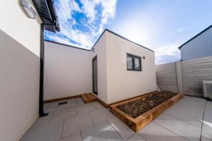 a white house with a garden on a balcony at Cozy Apartment in Dublin