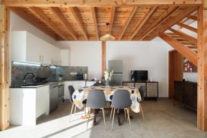 a kitchen and dining room with a table and chairs at FishTail Guest House in Rabo de Peixe +20 photos
