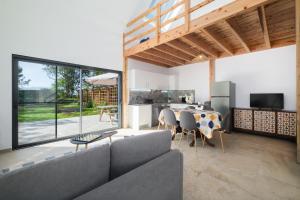 a living room with a couch and a table at FishTail Guest House in Rabo de Peixe