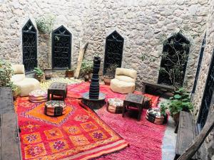 a room with a rug and chairs and a building at riad imlil in Imlil