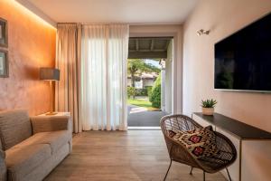 a living room with a couch and a chair at Splendido Bay Luxury Spa Resort in Padenghe sul Garda