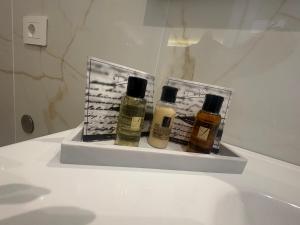 two bottles of essential oils sitting on a shelf in a bathroom at B&B Da Vinci in Cassano delle Murge +39 photos