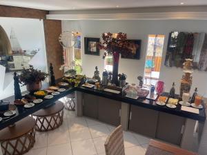 a kitchen with a counter with food on it at Pousada Macdonald in Eunápolis
