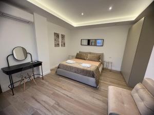 a bedroom with a bed and a mirror and a table at B&B Da Vinci in Cassano delle Murge