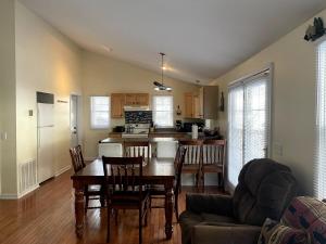 a kitchen and dining room with a table and chairs at Mountain home in Newland in Newland