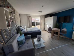 a living room with a couch and a bed at Ferienwohnung Luna in Stralsund