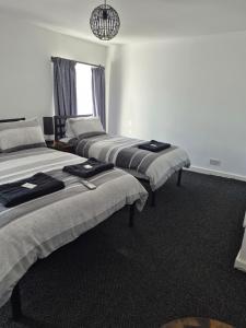 three beds are lined up in a room at The Last Post in Blackpool