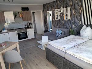 a living room with a bed and a kitchen at Ferienwohnung Luna in Stralsund
