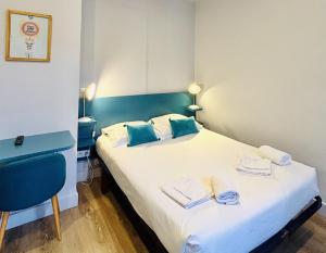 a bedroom with a bed with towels on it at La Carpe d'Or in Fontainebleau