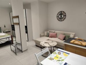a living room with a couch and a table at Corfu Nature Suites in Corfu