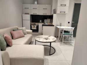 a living room with a couch and a table at Corfu Nature Suites in Corfu