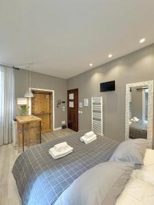 a bedroom with a bed with two towels on it at Cantore 20 - Le Arche Verona in Verona