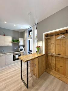 a kitchen with a wooden counter in a room at Cantore 20 - Le Arche Verona in Verona