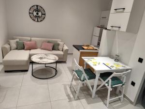 a living room with a couch and a table at Corfu Nature Suites in Corfu