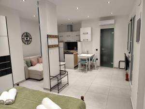 a large living room with a couch and a kitchen at Corfu Nature Suites in Corfu