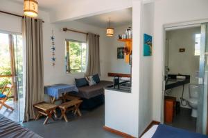 a small room with a bed and a bathroom at Vila Boa Vista Itacaré in Itacaré