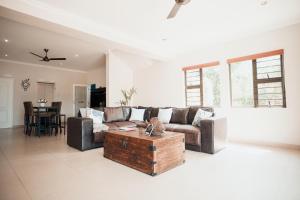 a living room with a couch and a coffee table at Megs Guesthouse in Ballito