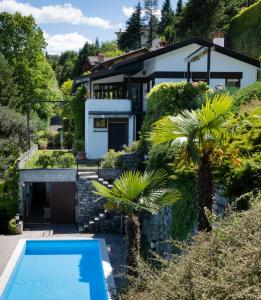 a house with a swimming pool in front of it at Villa Belvedere Panorama Lakeview - Lago di Como in Menaggio