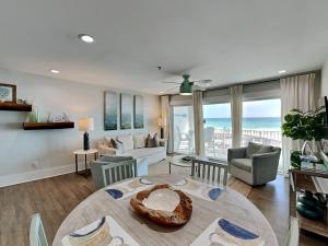 a living room with a table and a couch at Commodores Retreat #205 in Santa Rosa Beach