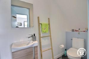 a bathroom with a sink and a mirror and a toilet at ô nid des grèves in Langueux +38 photos