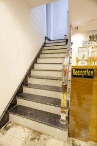 a staircase with a sign that reads reception at Hotel Golden Palace in Agra