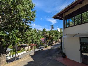 a street next to a building with palm trees at Carravensiria Chalet 27 in Hibberdene