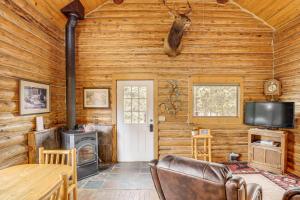 a log cabin with a fireplace and a stove at Wild Adventures in Eureka! Amish-Crafted Cabin in Eureka