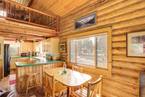 a kitchen with a table and chairs in a cabin at Wild Adventures in Eureka! Amish-Crafted Cabin in Eureka