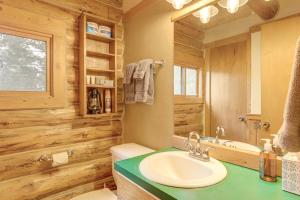 a bathroom with a sink and a toilet and a mirror at Wild Adventures in Eureka! Amish-Crafted Cabin in Eureka +20 photos