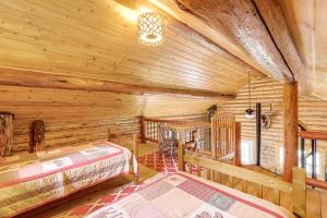 a log cabin bedroom with a bed and a desk at Wild Adventures in Eureka! Amish-Crafted Cabin in Eureka