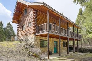 a log house with a balcony on the side of it at Wild Adventures in Eureka! Amish-Crafted Cabin in Eureka