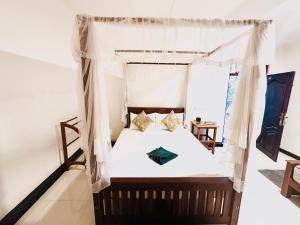 a bedroom with a bed with a canopy at Sigiriya Lahiru Homestay in Sigiriya