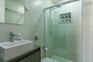 a bathroom with a glass shower and a sink at Charme da Santa Clara in Rio de Janeiro +24 photos