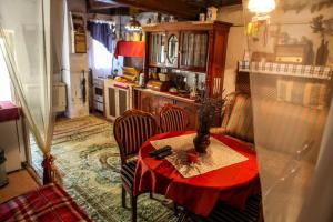 a kitchen with a table with a red table cloth at Görbe Vendégház in Tarcal
