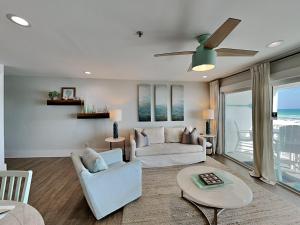 a living room with two couches and a ceiling fan at Commodores Retreat #205 in Santa Rosa Beach