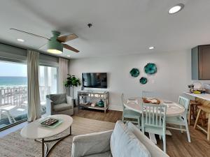 a living room with a couch and a table at Commodores Retreat #205 in Santa Rosa Beach