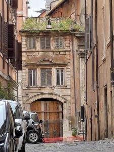 an old stone building with a large wooden door at Piazza del Popolo Suites in Rome