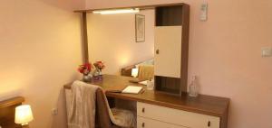 a bathroom with a dressing table and a mirror at Apartment Novi II in Kaštela