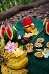 a bunch of bananas and fruit on a green leaf at Green Corner VILLA in Bukit Lawang