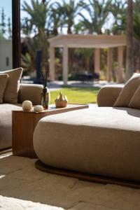a living room with two couches and a table at Villa Yliane in Marrakesh