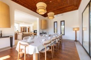 a large dining room with a white table and chairs at Villa Yliane in Marrakesh