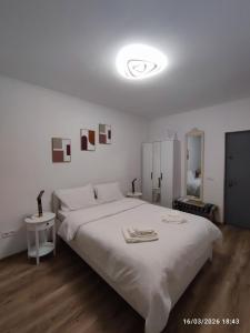 a bedroom with a large white bed with white sheets at Transilvania Studio in Sibiu