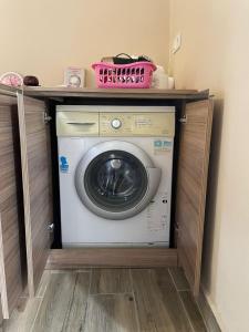 a washing machine with a shelf on top of it at Konak village housee in Ardeşen